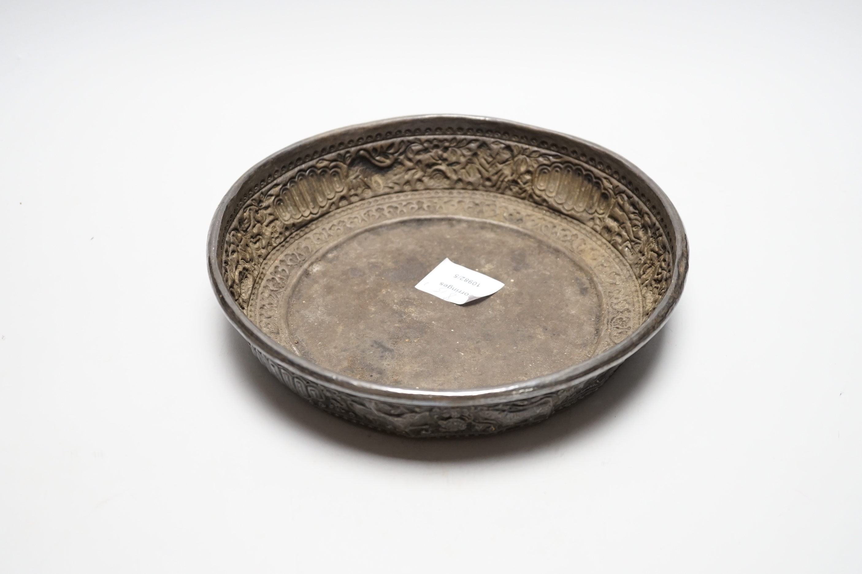 An Asian embossed white metal (tests as silver) shallow bowl, 25.2cm, 13.5oz.